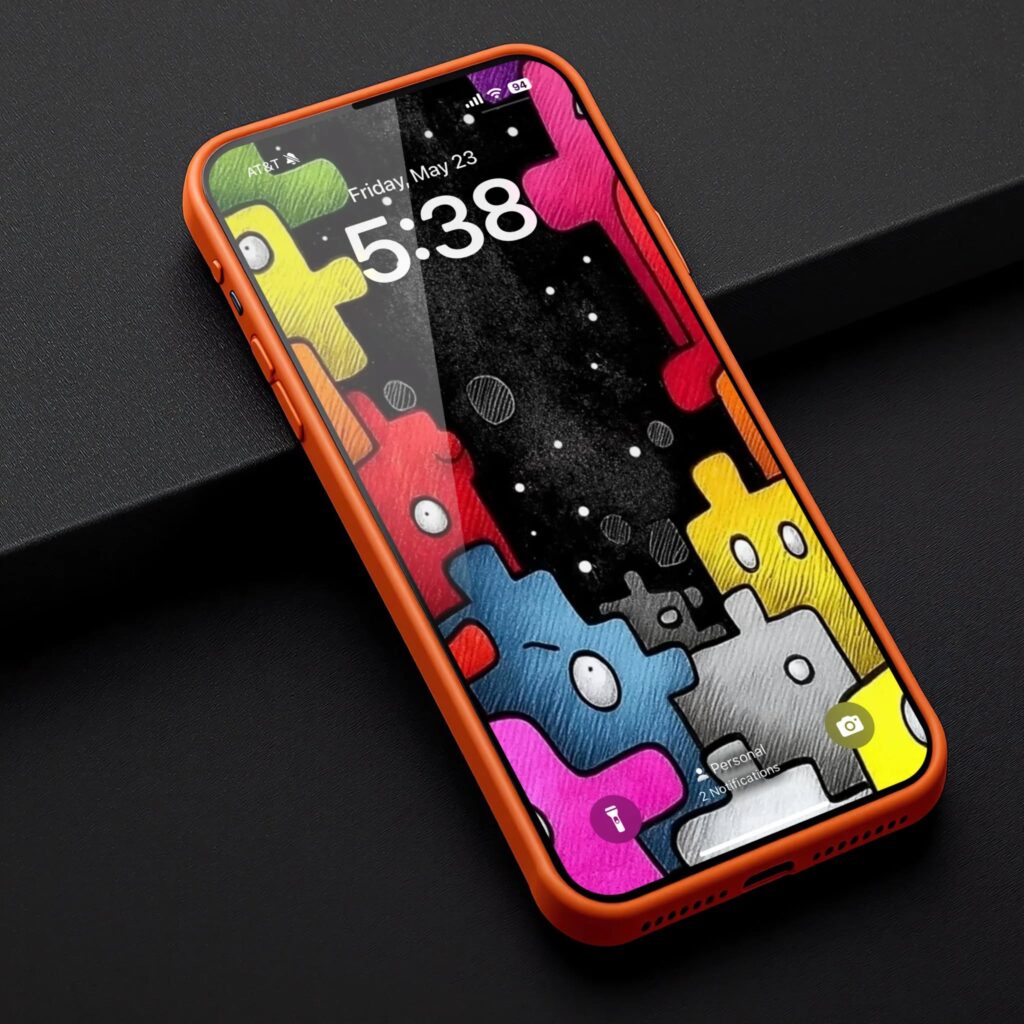 HD Playful Doodle Monsters Wallpaper Mockup: An orange phone showcases the wallpaper with its colorful monsters against a dark, speckled backdrop.